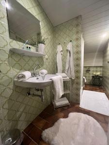 a bathroom with a sink and a mirror at Wolfbachgut - Ferienwohnung 5 in Taxenbach