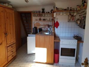 a small kitchen with a sink and a stove at Haus herhönspatziert in Willmars +15 photos