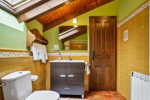 a bathroom with a toilet and a sink at Casa Jesusa in Gijón +22 photos