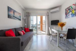a living room with a couch and a table at Lovely seaview apartment in Benalmadena Costa