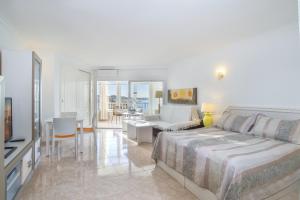 a bedroom with a bed and a living room at Penthouse studio with sea views in La Cala de Mijas