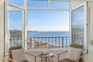 a room with two chairs and a view of the ocean at Penthouse studio with sea views in La Cala de Mijas