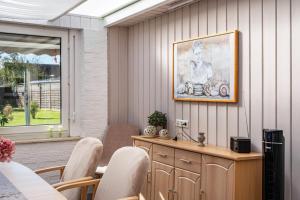 a room with a table and chairs and a picture on the wall at Ferienhaus Ihme in Sande