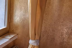 a shower curtain in a bathroom next to a window at Elegant Central Large House F1F2 in Gravedona +24 photos