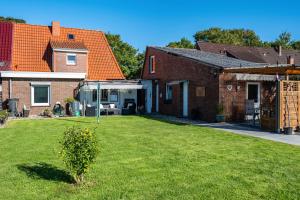 a yard with a house and a rv in it at Ferienhaus Ihme in Sande