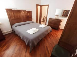 a bedroom with a bed with two napkins on it at Elegant Central Large House F1F2 in Gravedona