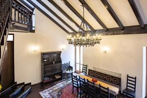 a dining room with a table and a chandelier at Elegant Central Large House F1F2 in Gravedona