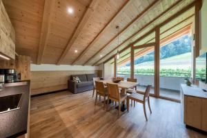 a kitchen and dining room with a table and chairs at Natur Suite Edelweisshof App Georg in Chiusa