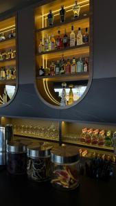 a bar with a shelf with bottles of alcohol at Casa Leon Hotel R Top in Rionegro