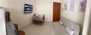 a living room with a couch and a table at 800m da UFV, 500m da rodoviária, Wi-Fi, TV smart. in Viçosa +20 photos