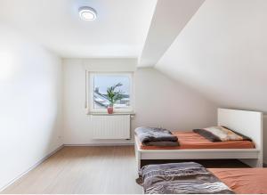 a bedroom with a bed and a window at Panda in Babenhausen