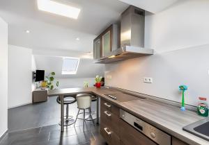 a kitchen with a sink and a counter top at Panda in Babenhausen +31 photos