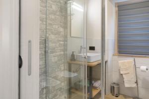 a bathroom with a glass shower and a sink at Ca Del Tita in Capo di Ponte +25 photos