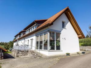 a white house with a red roof at Ferienwohnung Buchmann in Deggenhausertal