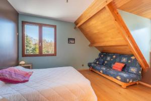 a bedroom with a bed and a stair case at Maison Vacances Vue Montagnes in Arras-en-Lavedan