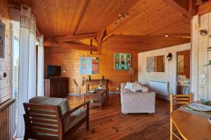 a living room with wooden walls and a wooden ceiling at Gite Escale Bien Etre à Biscarrosse in Biscarrosse