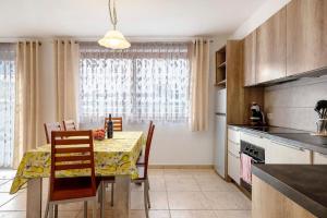 a kitchen with a table with chairs and a dining room at Night and day 4 in Predazzo +22 photos