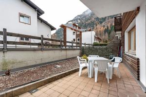 a patio with a table and chairs on a balcony at Night and day 4 in Predazzo