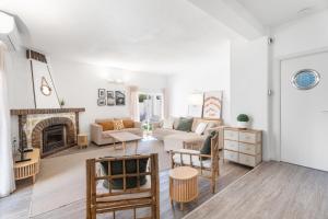 a living room with a couch and a fireplace at Chalet Saler in Valencia