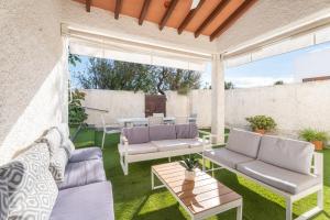 a patio with two couches and a table at Chalet Saler in Valencia
