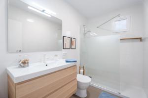 a bathroom with a white sink and a toilet at Chalet Saler in Valencia +33 photos