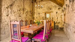 a dining room with a wooden table and chairs at Ferienwohnungen Altes Rathaus in Vogtsburg