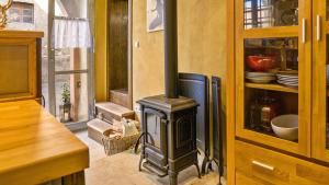 a wood stove in a kitchen with a counter at Ferienwohnungen Altes Rathaus in Vogtsburg +71 photos