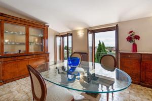 a dining room with a glass table and chairs at Casa Solarolo in Montinelle