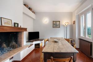 a living room with a table and a fireplace at Casa Solarolo in Montinelle