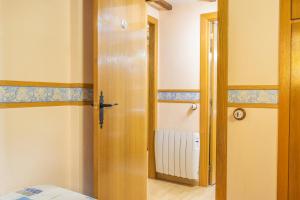 a room with a door leading to a bedroom at Apartamento La Mainera in Espot
