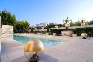 a large swimming pool with silver balls in the middle at Maison Boutique At Viviana in San Pietro in Lama