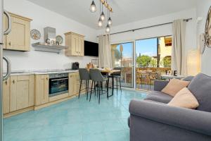 a kitchen and living room with a couch and a table at Colombo Apartment - by And Service in Golfo Aranci