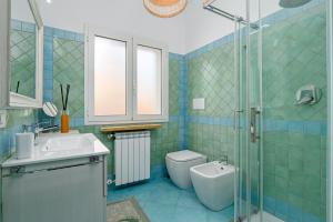a bathroom with a sink and a toilet and a shower at Colombo Apartment - by And Service in Golfo Aranci +16 photos