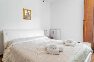 a bedroom with a white bed with towels on it at Barsotti House - Lucca in Lucca