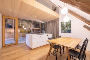 a kitchen and dining room with a wooden table and chairs at Lippenhof - Unter der Linde in Unterkirnach +26 photos