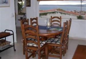a dining room table and chairs with a view of the ocean at Casa Jazmin in Roses