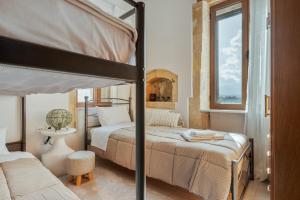 a bedroom with a bunk bed and a window at Palailimnos in Palaiólimnos