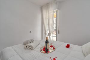 a white bed with a bottle of wine on it at La Mejor in Torrox +36 photos