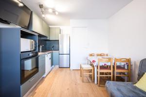 a kitchen with a table and a dining room at Appartement Les Menuires in Les Menuires