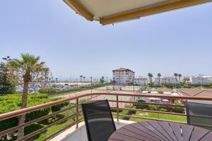 a balcony with an umbrella and a table and chairs at La Mejor in Torrox