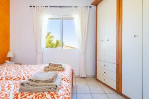 a bedroom with a bed and a window at Villa Individual Peñíscola in Peniscola +26 photos