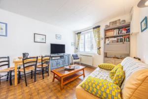 a living room with a couch and a table at Maison vacances La Terrière in La Tranche-sur-Mer