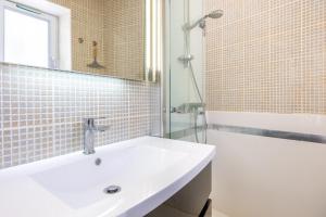 a white bathroom with a sink and a shower at Maison vacances La Terrière in La Tranche-sur-Mer +19 photos