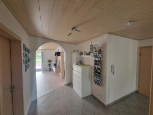 a hallway with a white refrigerator in a room at Ferienwohnung Biosphärenblick in Münsingen