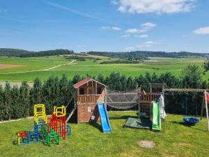 a group of childrens playground equipment in the grass at Ferienwohnung Biosphärenblick in Münsingen