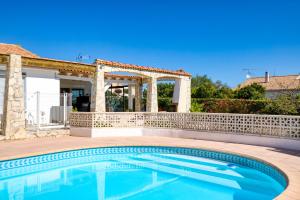 a swimming pool in a backyard with a gazebo at Chez Gaston - Chambre in Saint-Drézéry