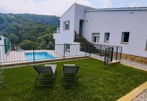 two chairs sitting on a balcony of a house at Casa Nuestra in Begur