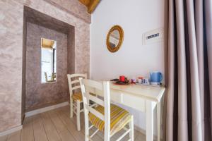 a kitchen with a table and chairs in a room at Antico Casale Gioiosa Marea in Gioiosa Marea