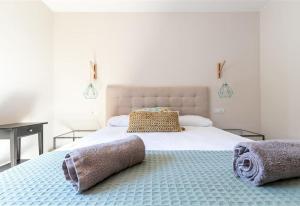 a bedroom with a large white bed with two pillows at Casa Nuestra in Begur +27 photos