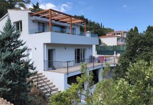 a white house with a balcony on a hill at Casa Nuestra in Begur